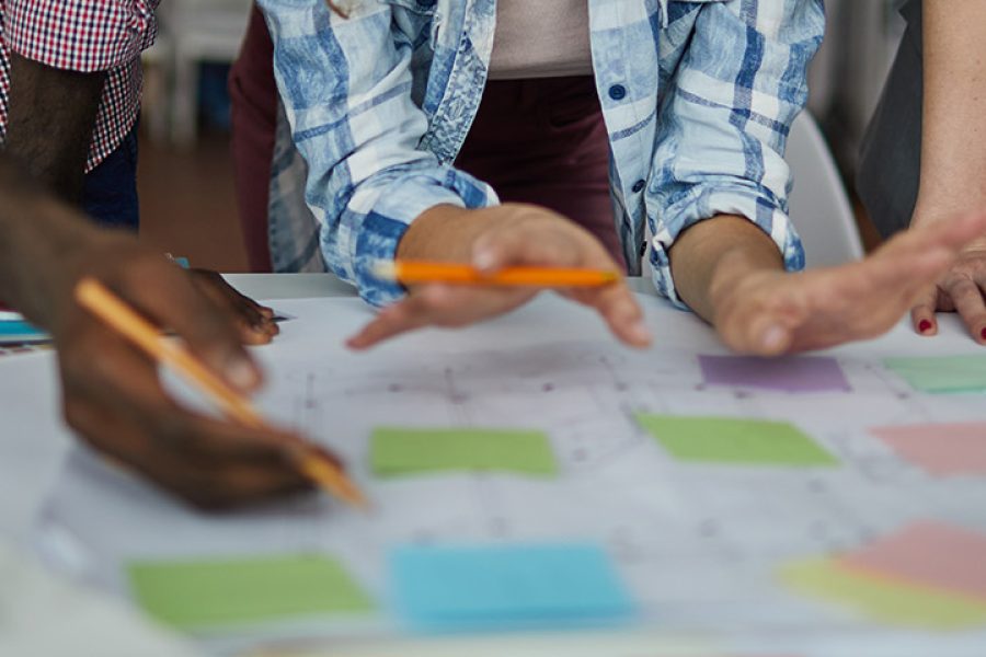 Mid section shot of creative team planning project drawing roadmap in office, copy space
